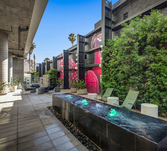 A modern outdoor seating area with a water feature in the center.