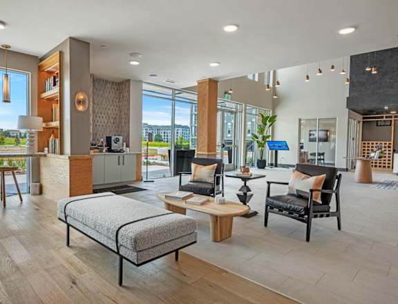 A modern living room with a large window overlooking a green landscape.