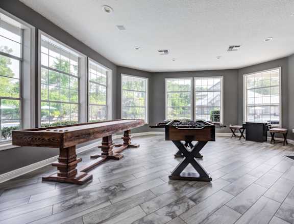 Lounge and Game Room with Mrs. Pac Man and Sand Shuffle Board at Paradise Island Apartments, Jacksonville, FL 32256