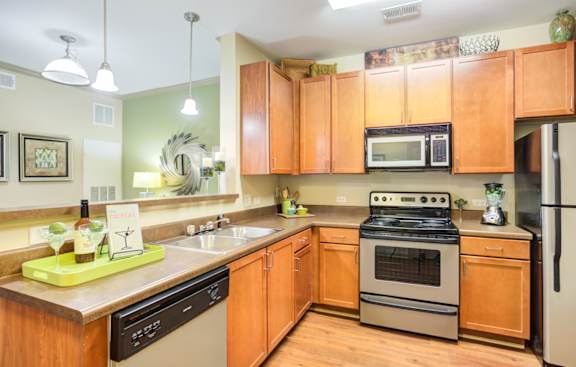 a kitchen with wooden cabinets and stainless steel appliances