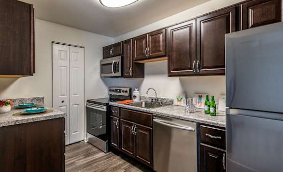full kitchen with stainless steel appliances at the reserve at walnut creek apartments