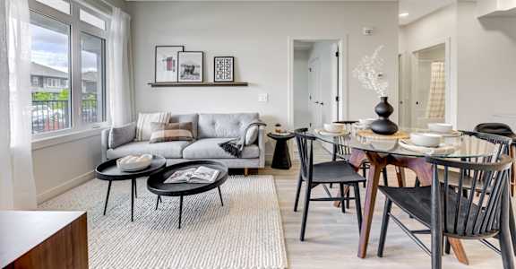 a living room and dining room with a table and chairs and a couch