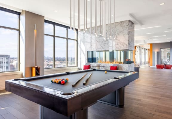 a billiards table in a game room with a view of the city