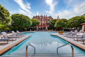 Three-Bedroom Apartments In Hendersonville, TN - The Grove at Waterford Crossing - Sparkling Swimming Pool With Spacious Sundeck, Lounge Chairs, Umbrellas, And Surrounding Trees.
