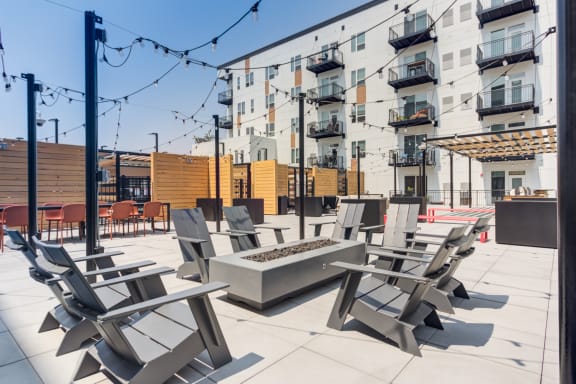 a patio with chairs and a firepit at the axis at walnut creek apartments