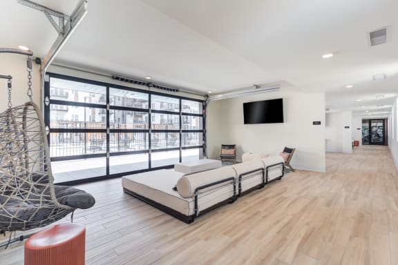 a living room with white walls and hardwood floors