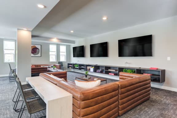 the heights club room with couches and flat screen televisions
