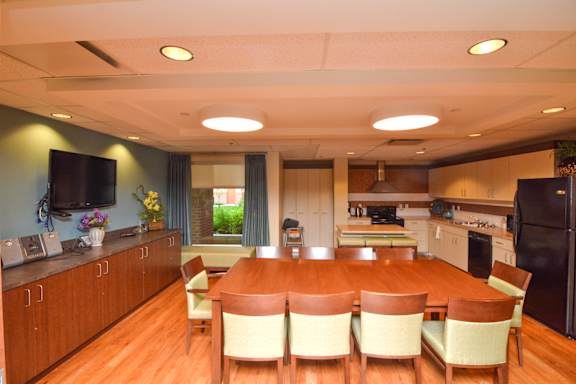 A kitchen with a table and chairs in the middle.