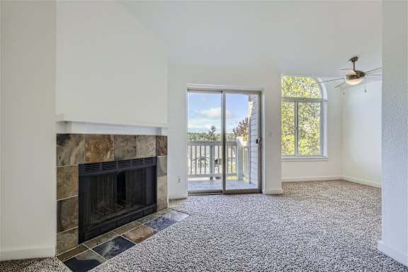 A living room with a fireplace and carpeted floor.