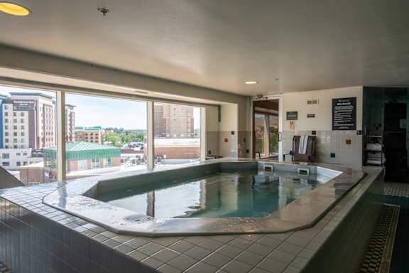 an indoor hot tub in a building with a view of the city at The Lucy Boise Apartments, Boise, ID