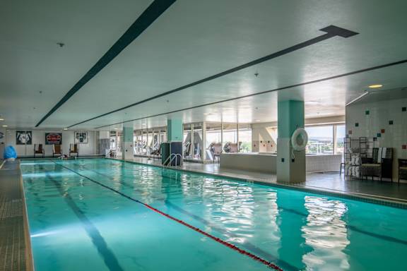 a swimming pool in a gym with a blue water at The Lucy Boise Apartments, Boise, ID