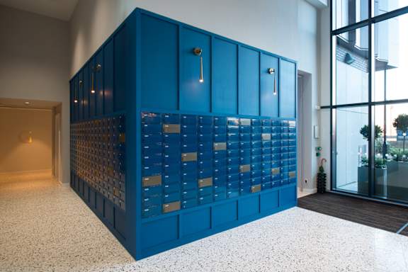 A blue cabinet with a glass door is in the middle of the room.