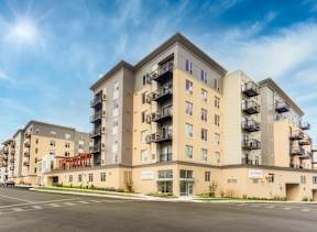 new apartment buildings on the corner of a street