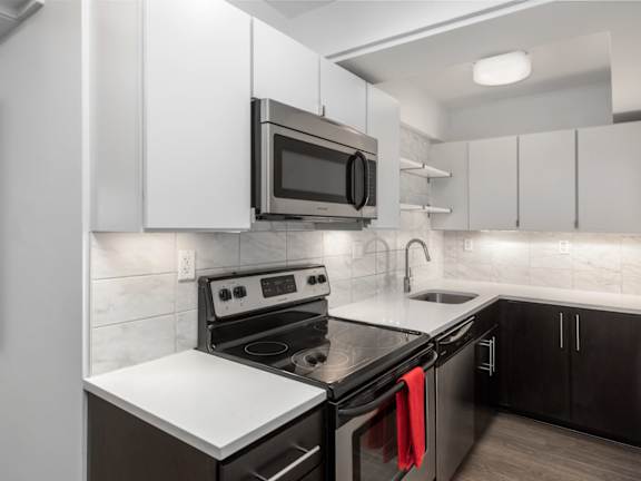 A modern kitchen with a black and white color scheme.