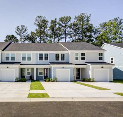 a house with blue siding and white doors and shutters