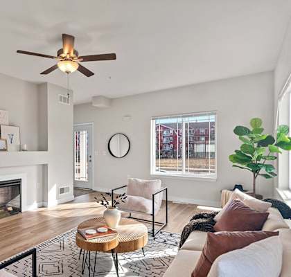 a living room with a couch and a ceiling fan at The Residences Apartments at Bear Tree | DeForest, WI, Wisconsin
