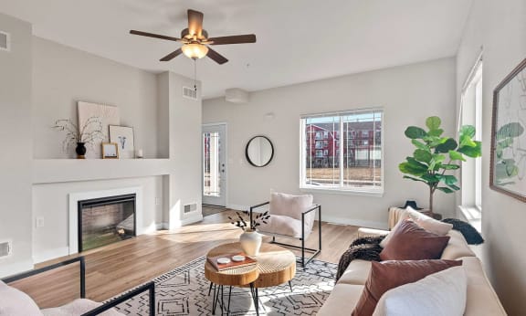 a living room with a couch and a ceiling fan at The Residences Apartments at Bear Tree | DeForest, WI, DeForest, 53532