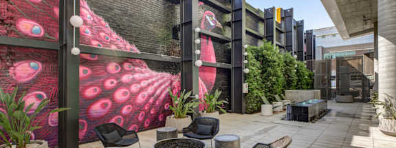 Fusion Hollywood patio with a peacock mural on the wall.