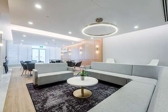 A modern living room with a grey sofa and a coffee table.