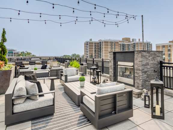 A patio with furniture and string lights.