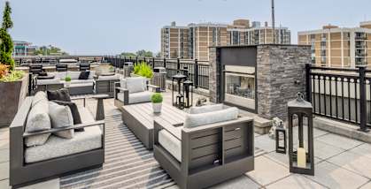 A patio with furniture and string lights.
