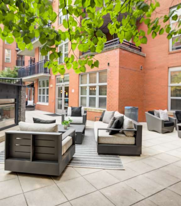 A patio with furniture and string lights.