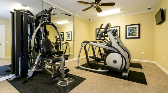 a home gym with exercise equipment and a large mirror