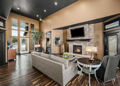 a living room with a fireplace and a table and chairs