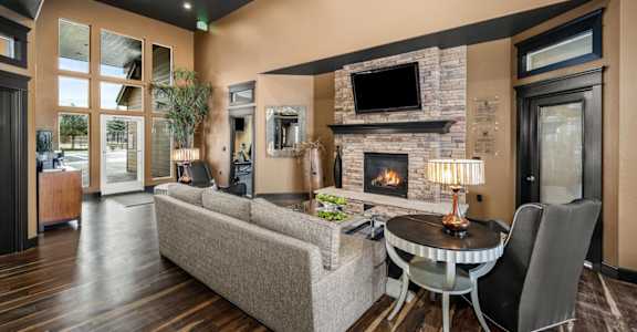 a living room with a fireplace and a table and chairs