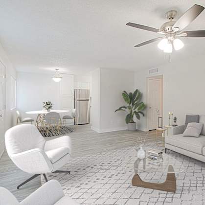 A living room with a white chair and a white couch.