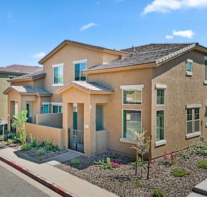 A row of houses with a red curb in front.