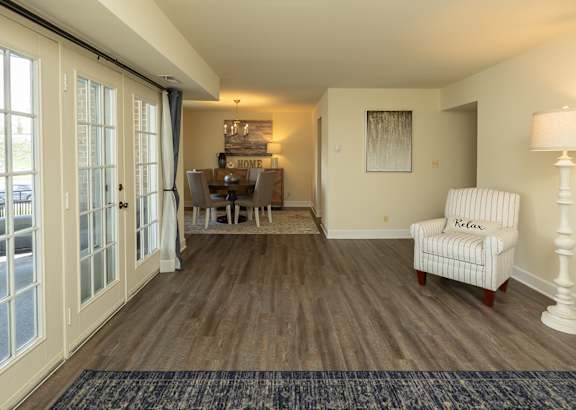A living room with a chair and a lamp at The Brittany Apartments, Maryland, 21208