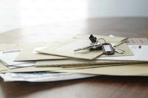 a bunch of keys on a pile of papers on a table