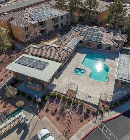 A large house with a pool and solar panels on the roof.