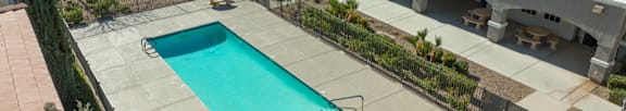 A swimming pool in front of apartment buildings.