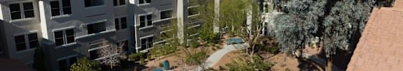 A swimming pool in front of apartment buildings.