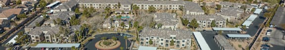 A large building with a pool in the middle of a courtyard surrounded by other buildings.
