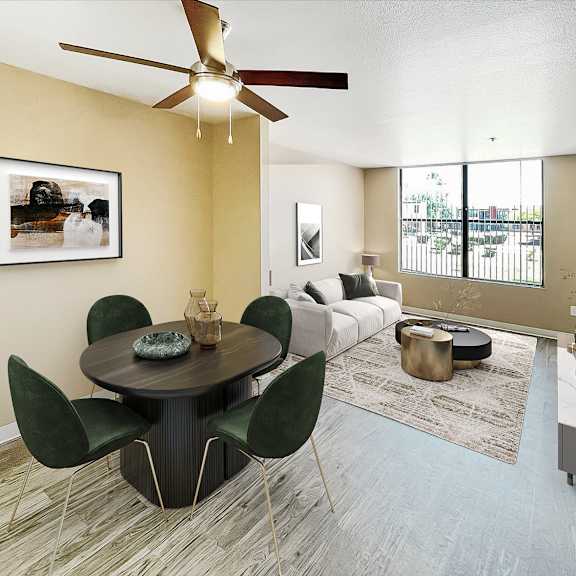 A modern dining room with a round table and green chairs.