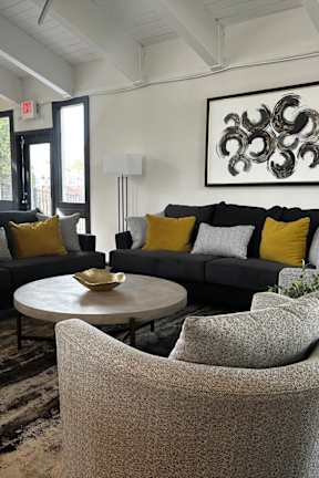 a living room with couches and chairs and a coffee table