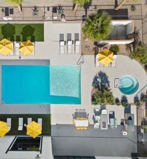arial view of a pool area with umbrellas and a swimming pool