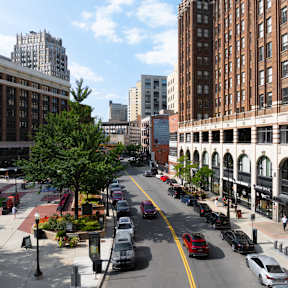 a view of a street in a city with tall buildings