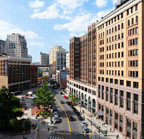 an aerial view of a city street with tall buildings