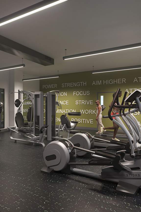 A gym with a variety of equipment and a sign that reads "POWER STRENGTH AIM HIGHER ATTAIN".