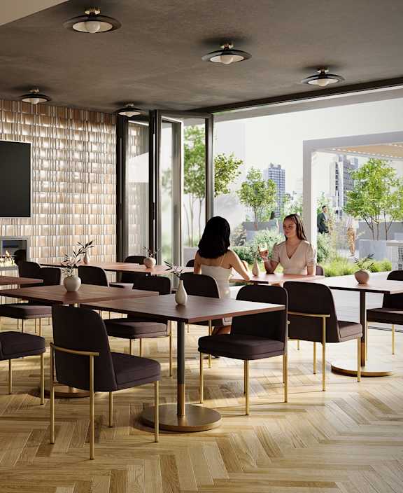 A conference room with a long table and chairs, a television on the wall, and a view of the city outside the windows.