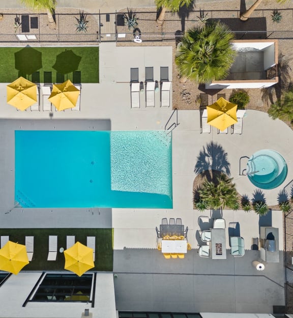arial view of a pool area with umbrellas and a swimming pool