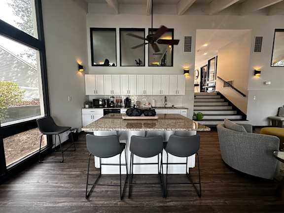 a kitchen and dining room with a marble table and chairs