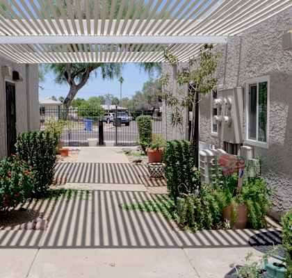 A striped walkway leads to a building entrance.
