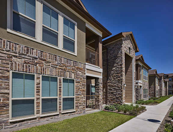 A row of houses with stone and brick exteriors.