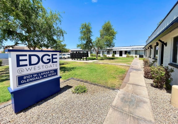 a building with a blue and white sign that says edge westgate