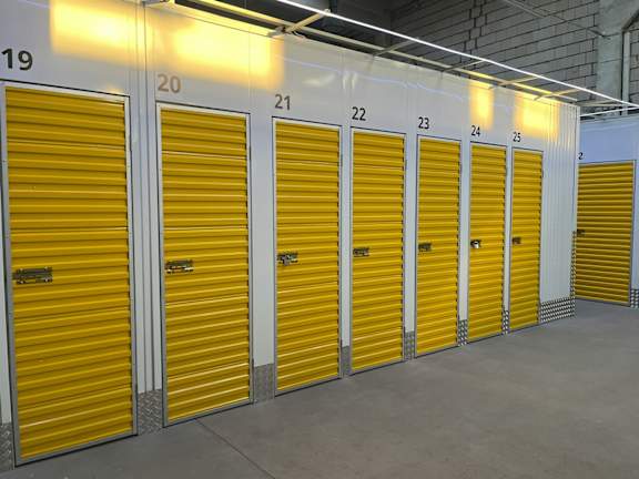 A series of yellow storage units are numbered from 19 to 25.